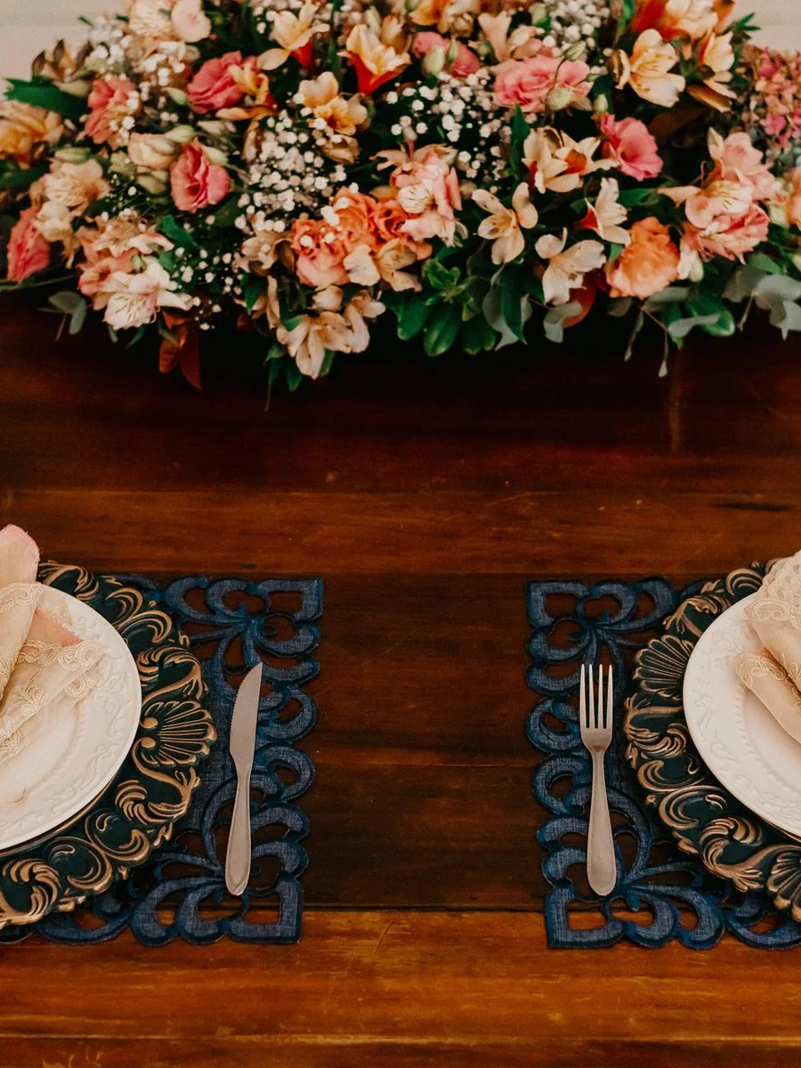 Wooden dough bowl of wildflowers on a dining table